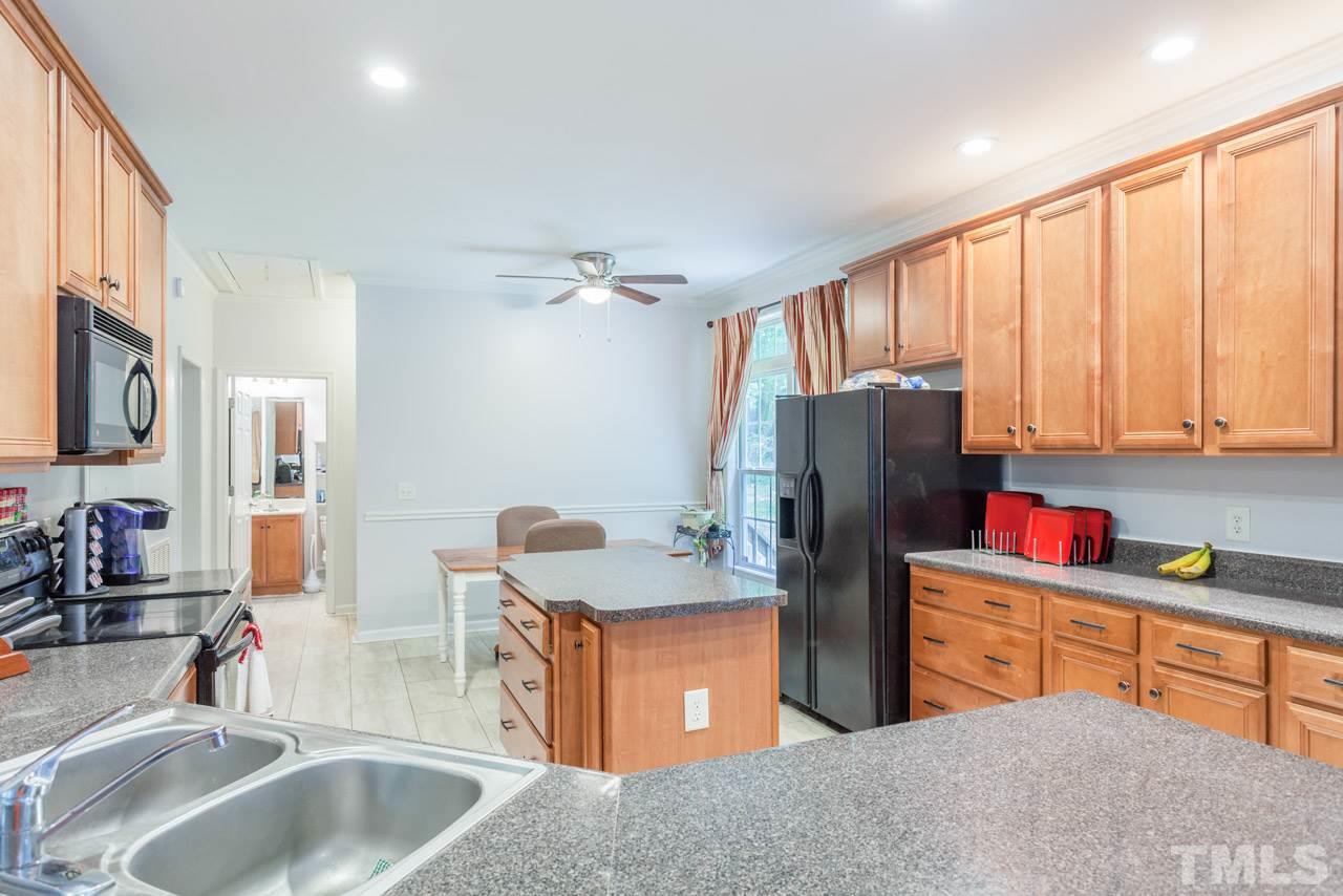 2092 Suitts Store Road Franklinton, NC 27525 - Photo 7 of 21 a kitchen with stainless steel appliances granite countertop a sink dishwasher and a refrigerator with wooden floor