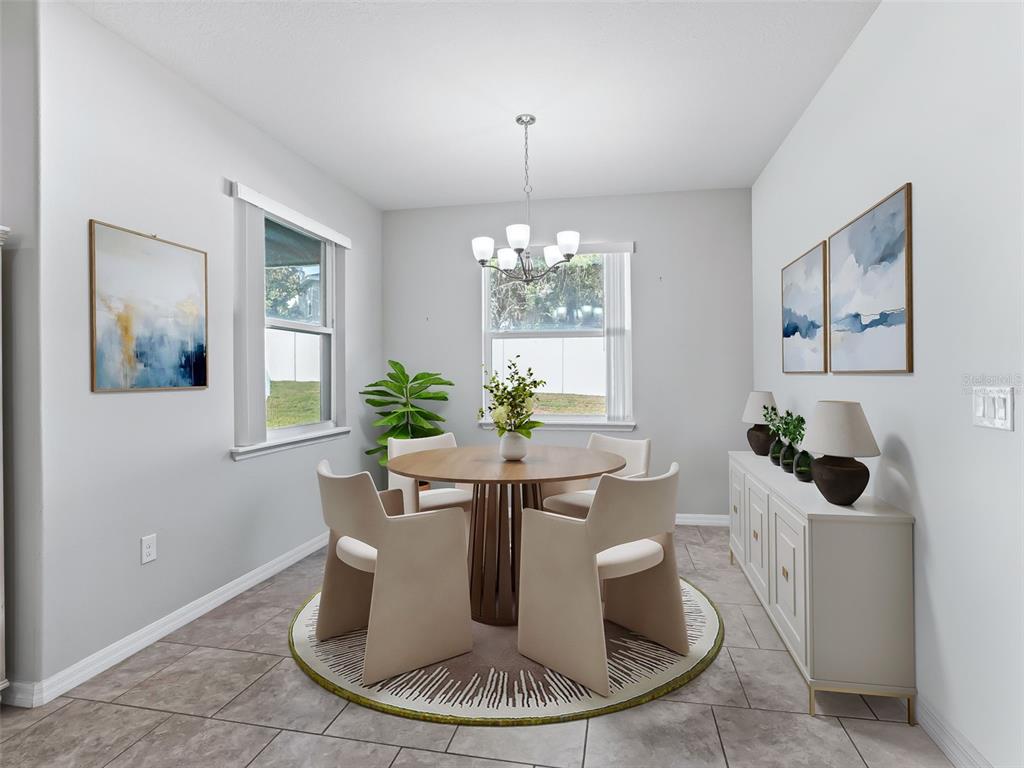 5626 Southwest 50th Court Ocala, FL 34474 - Photo 13 of 33 a dining room with table chairs and a chandelier