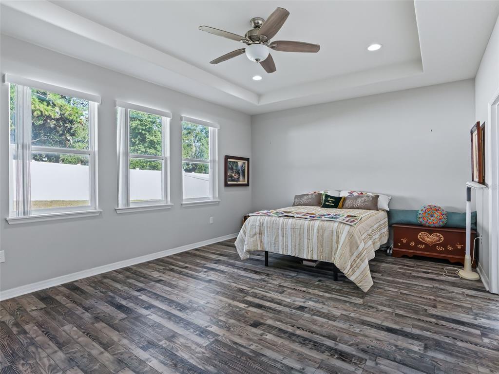 5626 Southwest 50th Court Ocala, FL 34474 - Photo 14 of 33 a bedroom with a bed and wooden floor