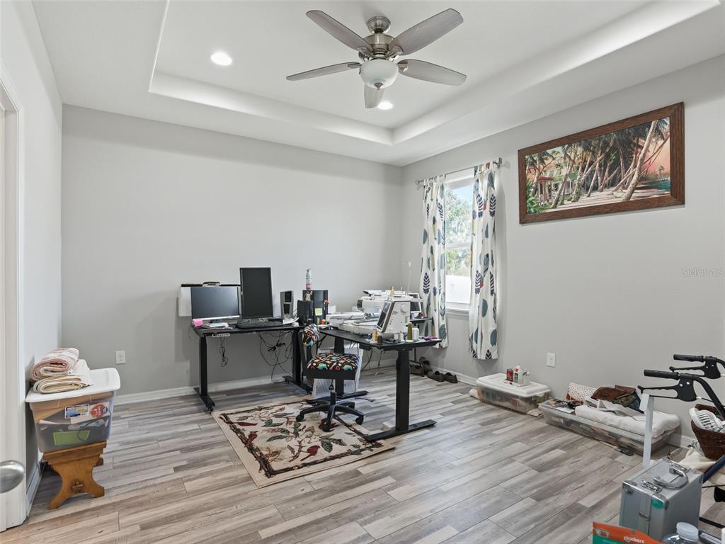 5626 Southwest 50th Court Ocala, FL 34474 - Photo 22 of 33 a living room with furniture a rug and a ceiling fan