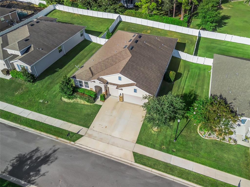 5626 Southwest 50th Court Ocala, FL 34474 - Photo 28 of 33 an aerial view of a house with a garden and trees