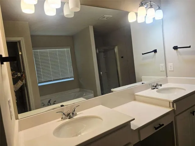 a bathroom with a sink a vanity and a mirror