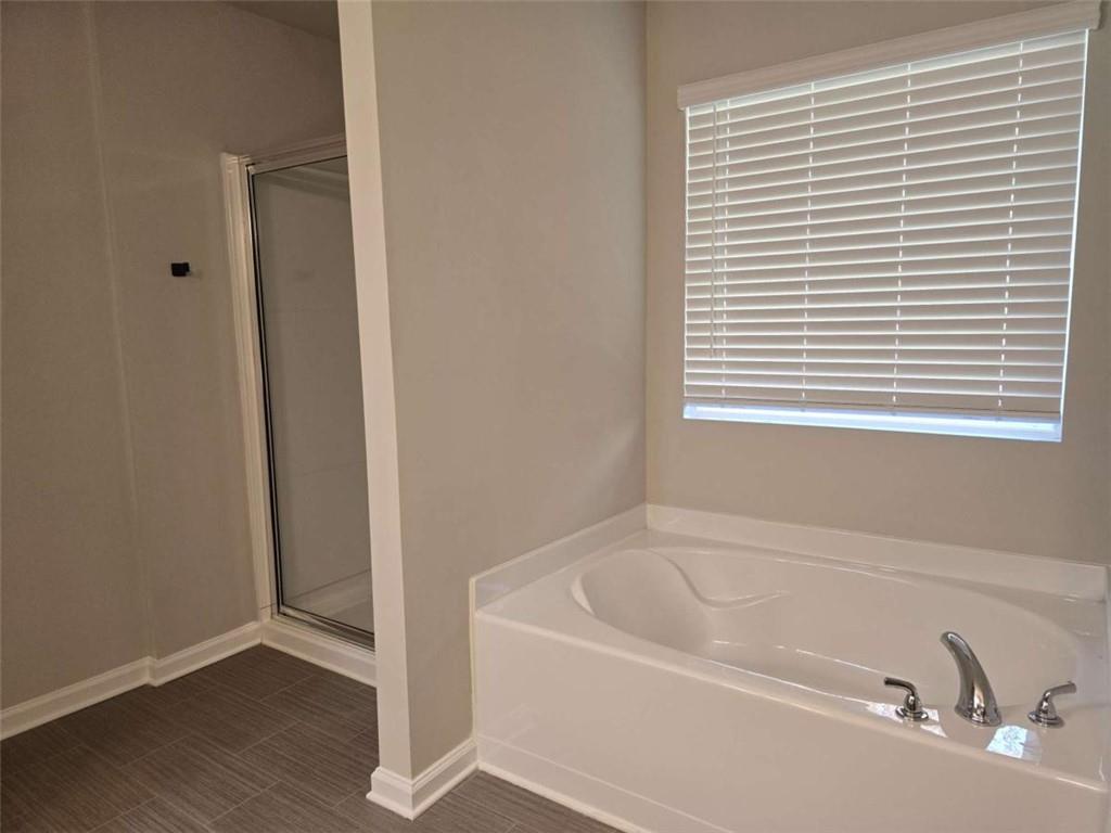 213 North Fortune Way Dallas, GA 30157 - Photo 16 of 24 a white bath tub sitting next to a window