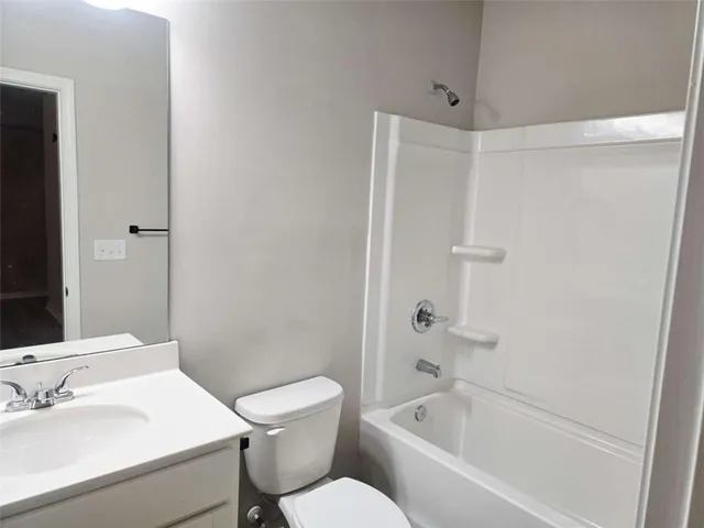 a bath room with a toilet a sink and a bath tub
