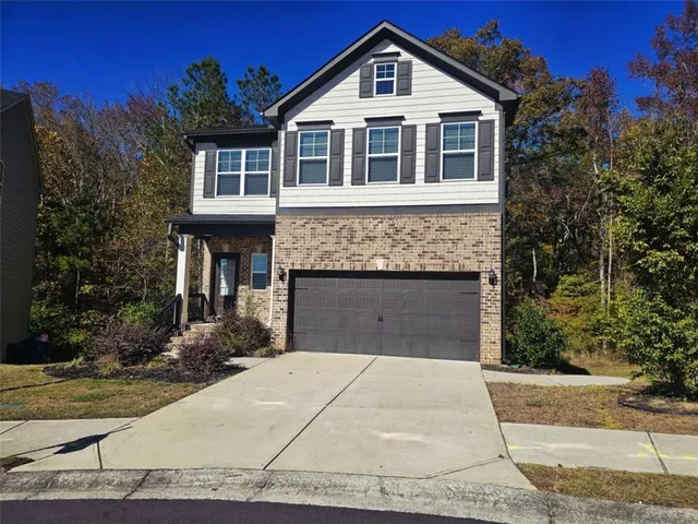 a front view of a house with yard