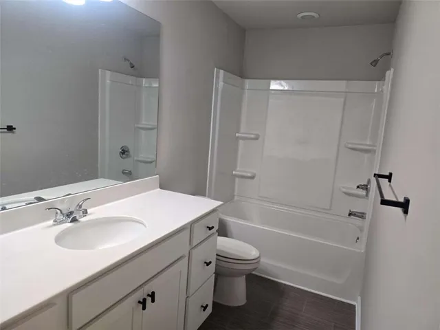 a bathroom with a sink toilet tub and shower