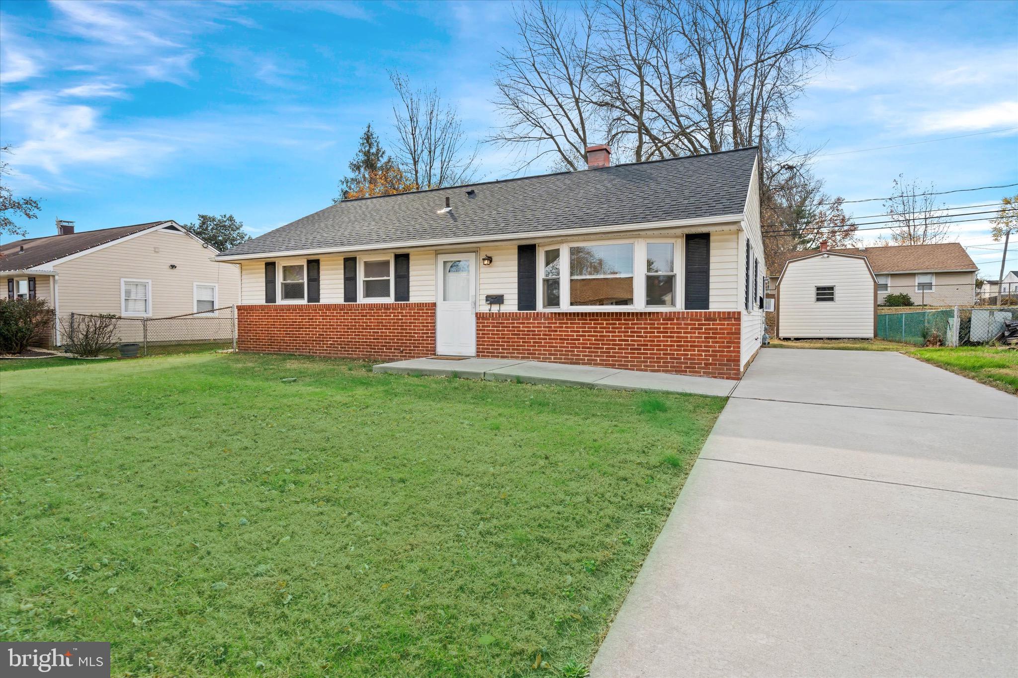 a front view of a house with a garden and yard