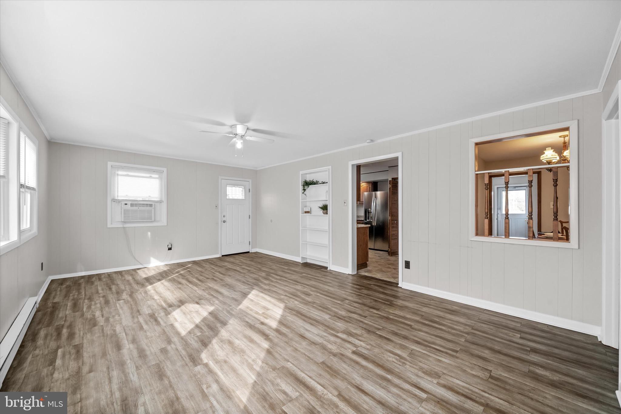 124 Festone Avenue New Castle, DE 19720 - Photo 20 of 43 a view of an empty room with window and wooden floor