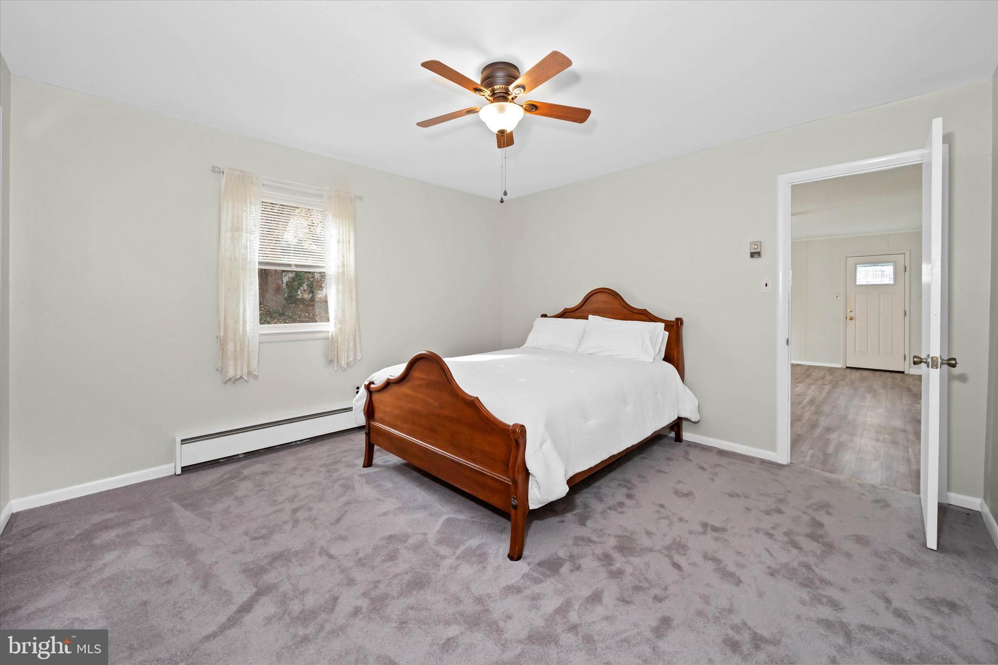124 Festone Avenue New Castle, DE 19720 - Photo 24 of 43 a bedroom with a bed and a chandelier