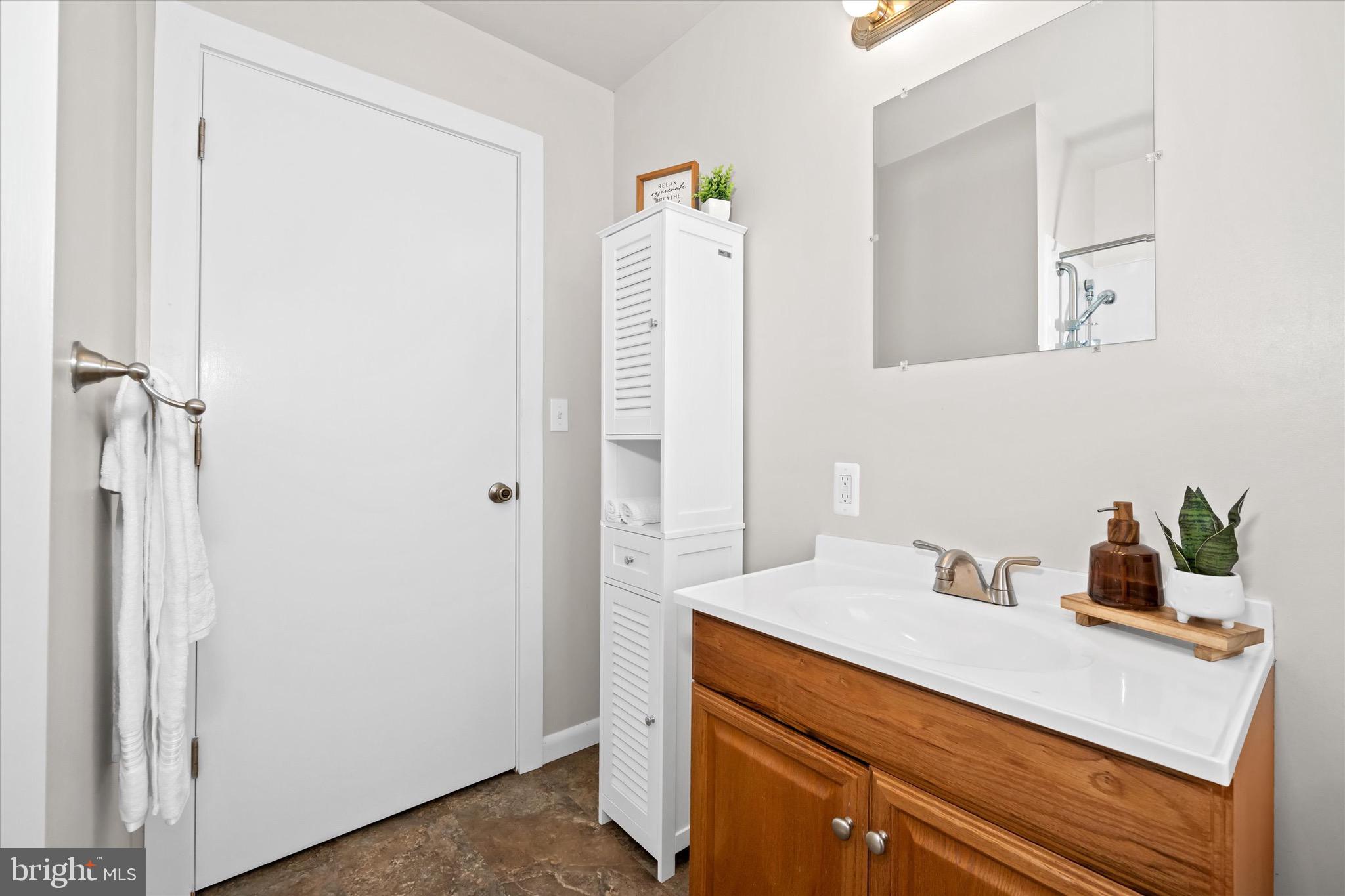 124 Festone Avenue New Castle, DE 19720 - Photo 31 of 43 a bathroom with a sink vanity and a mirror