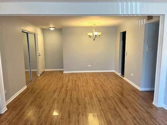 1201 Pleasant Run Drive, Unit 307 Wheeling, IL 60090 - Photo 3 of 7 a view of empty room with wooden floor