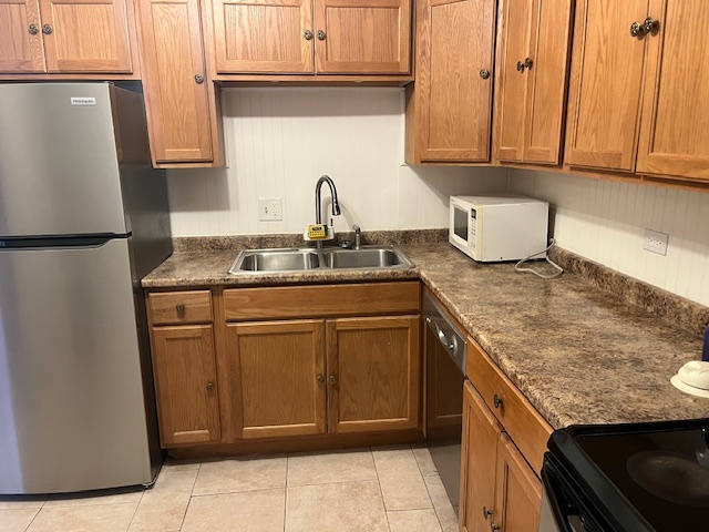 1201 Pleasant Run Drive, Unit 307 Wheeling, IL 60090 - Photo 4 of 7 a kitchen with stainless steel appliances granite countertop a refrigerator sink and cabinets