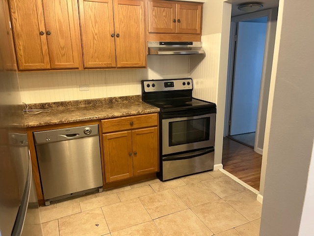 1201 Pleasant Run Drive, Unit 307 Wheeling, IL 60090 - Photo 5 of 7 a kitchen with stainless steel appliances granite countertop a stove a microwave and a sink