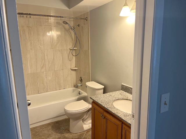 1201 Pleasant Run Drive, Unit 307 Wheeling, IL 60090 - Photo 6 of 7 a bathroom with a granite countertop bathtub shower sink mirror and toilet