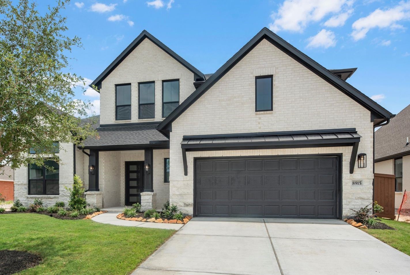 8915 Acropolis Lane Manvel, TX 77578 - Photo 1 of 32 a front view of a house with garden