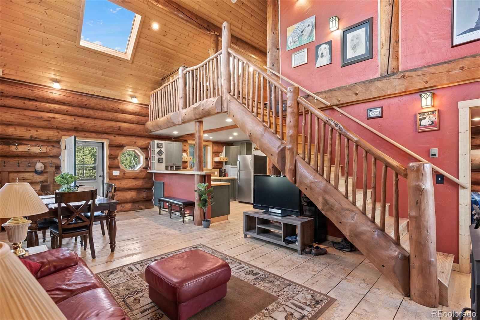 96 Eva Road Idaho Springs, CO 80452 - Photo 11 of 34 a view of a patio with couches table and chairs with wooden floor