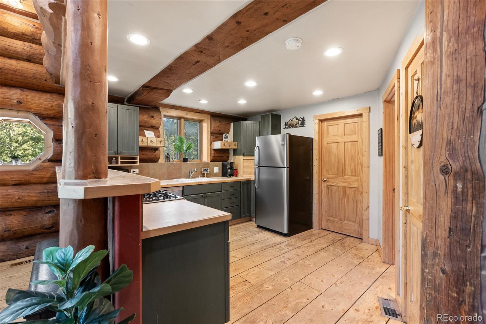 96 Eva Road Idaho Springs, CO 80452 - Photo 15 of 34 a kitchen with refrigerator and cabinets