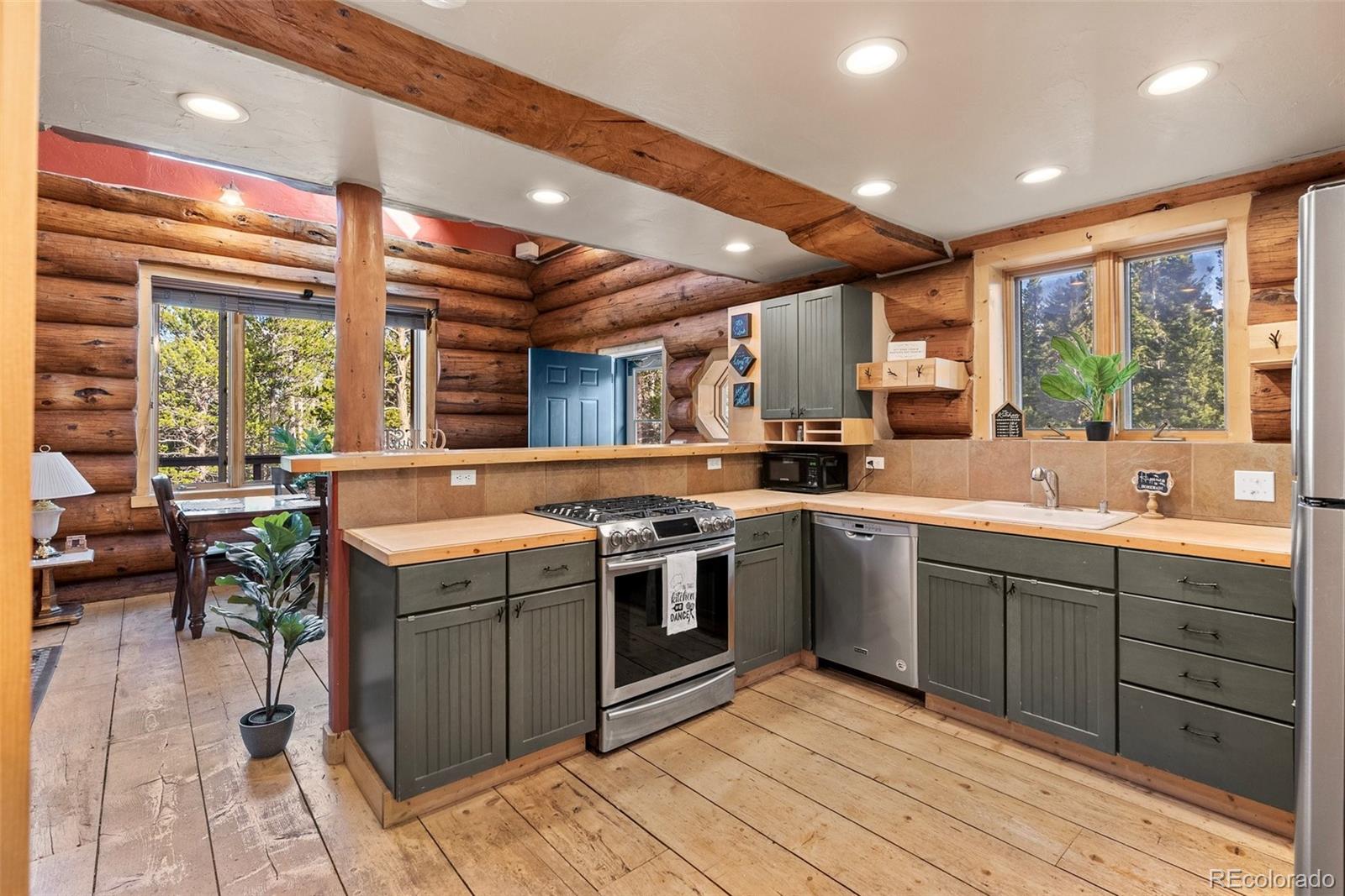 96 Eva Road Idaho Springs, CO 80452 - Photo 16 of 34 a kitchen with stainless steel appliances granite countertop a stove a sink and a microwave