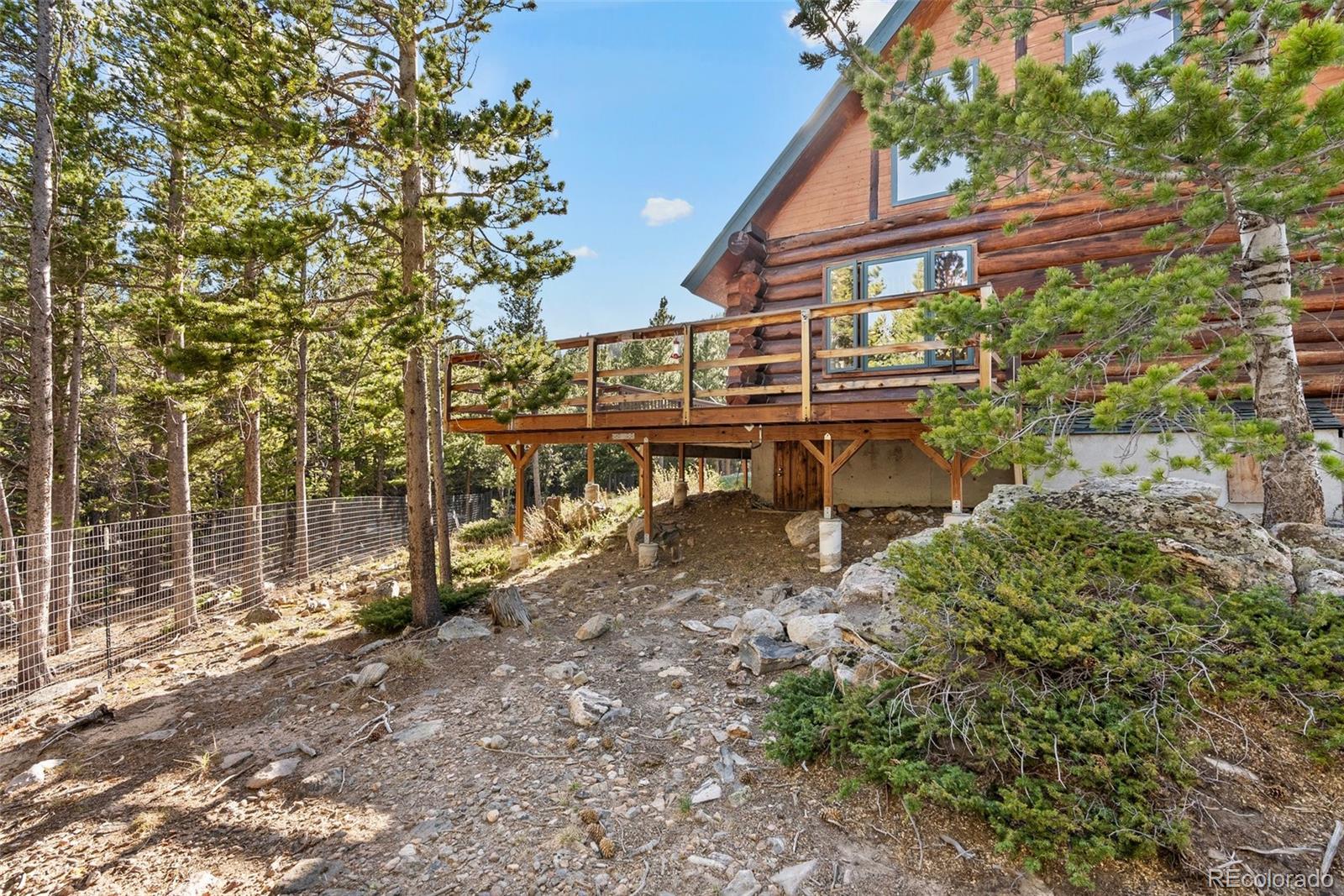 96 Eva Road Idaho Springs, CO 80452 - Photo 27 of 34 a backyard of a house with table and chairs