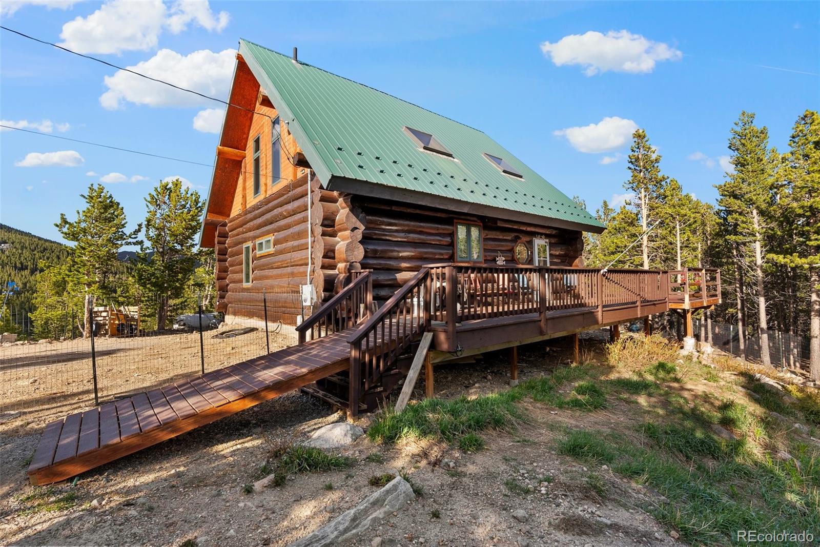 96 Eva Road Idaho Springs, CO 80452 - Photo 30 of 34 a backyard of a house with a yard and outdoor seating