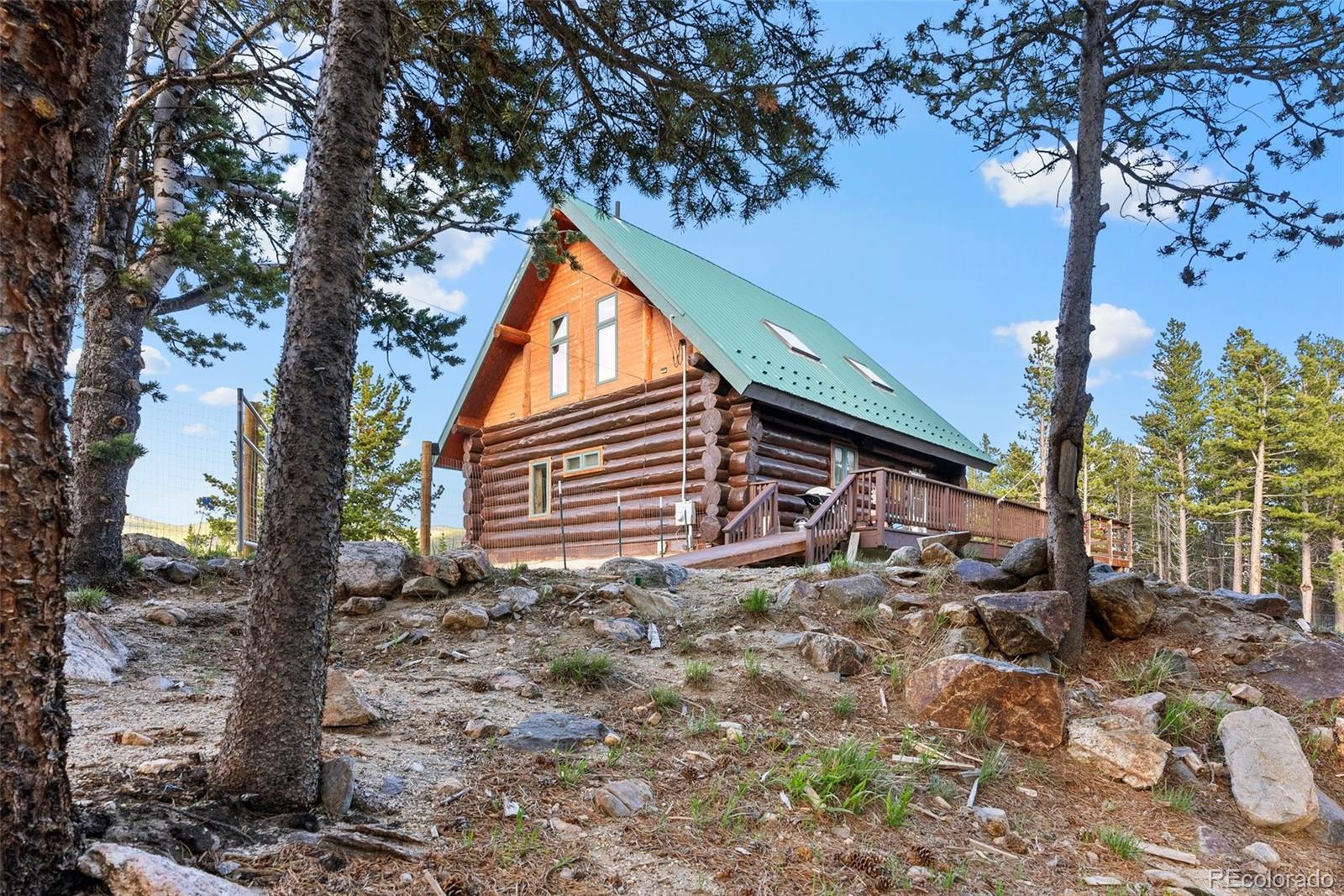 96 Eva Road Idaho Springs, CO 80452 - Photo 5 of 34 a backyard of a house with lots of green space