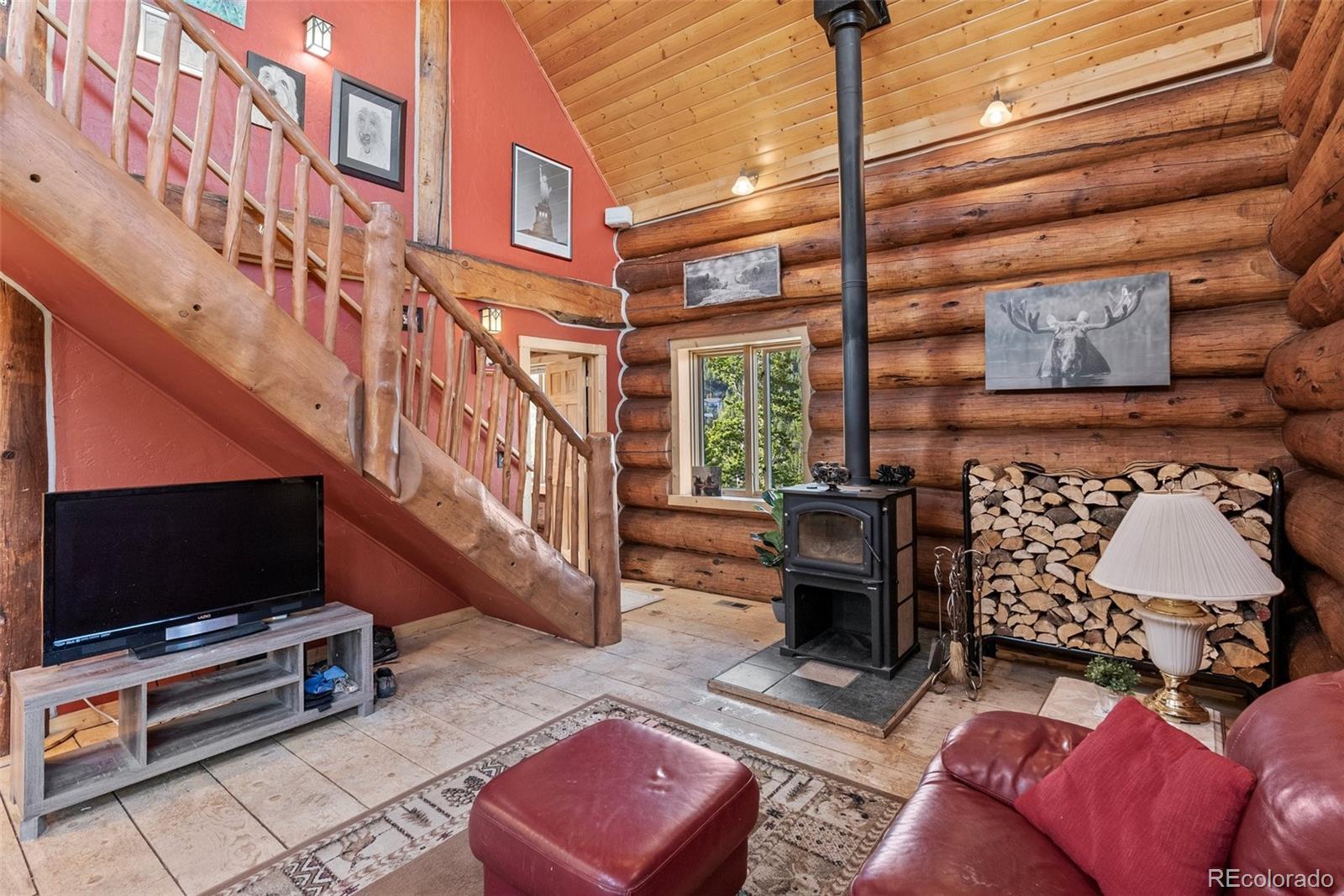 96 Eva Road Idaho Springs, CO 80452 - Photo 10 of 34 a living room with furniture and a flat screen tv