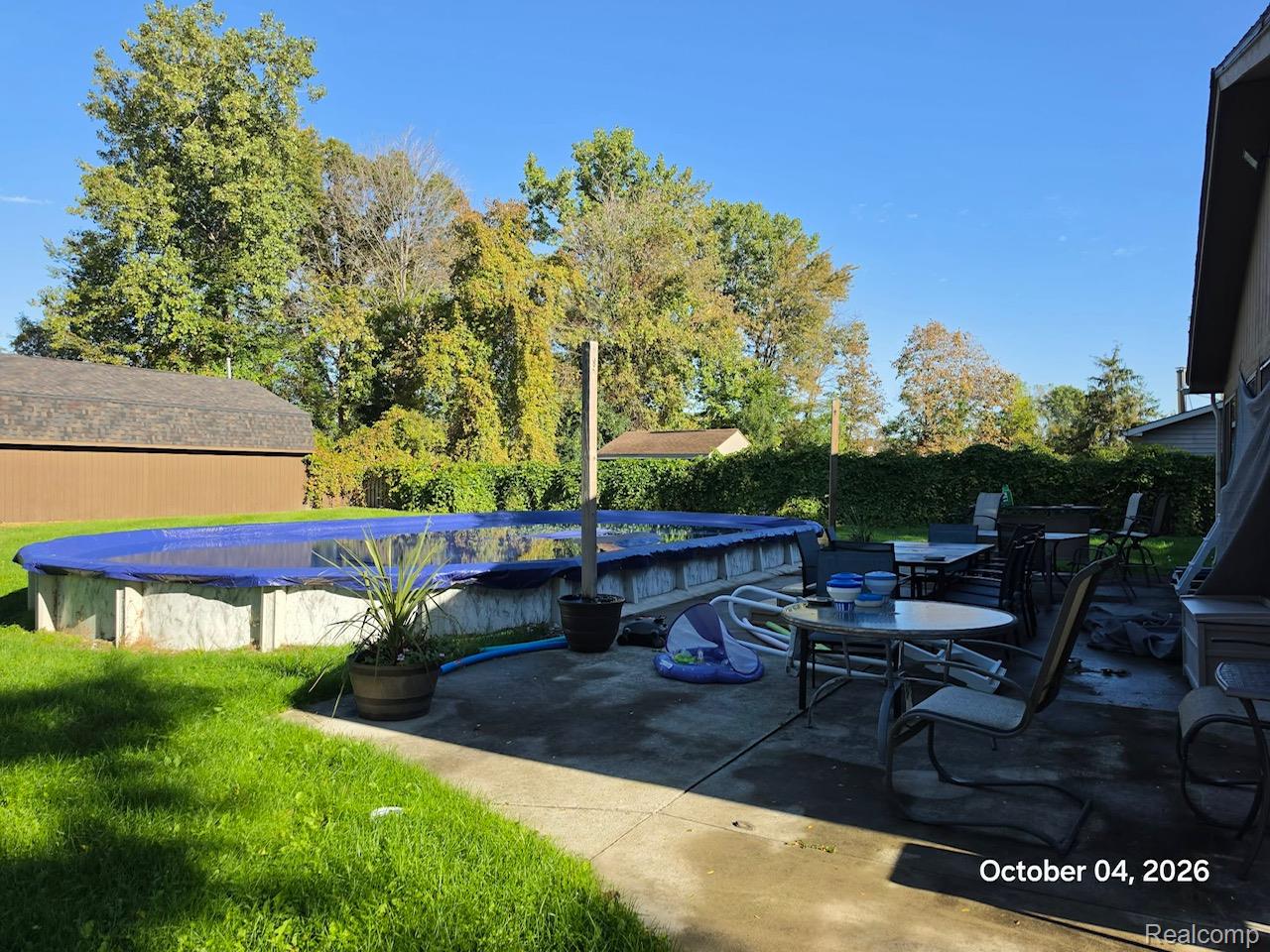 34781 Union Lake Road Clinton Township, MI 48035 - Photo 37 of 38 Expansive concrete patio with an adjacent above-ground pool