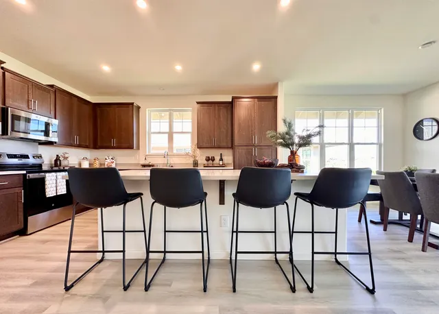 a dining room with furniture a window and kitchen view