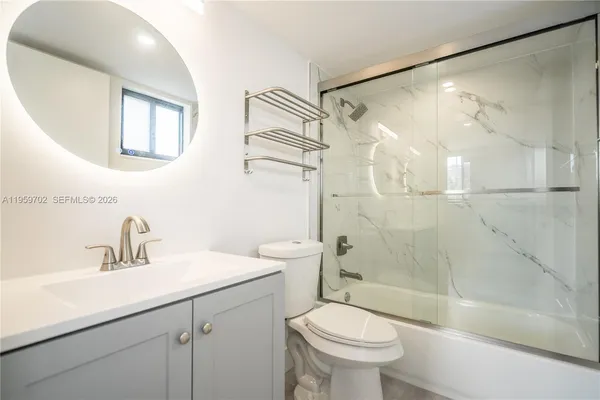 a bathroom with a sink shower and a toilet