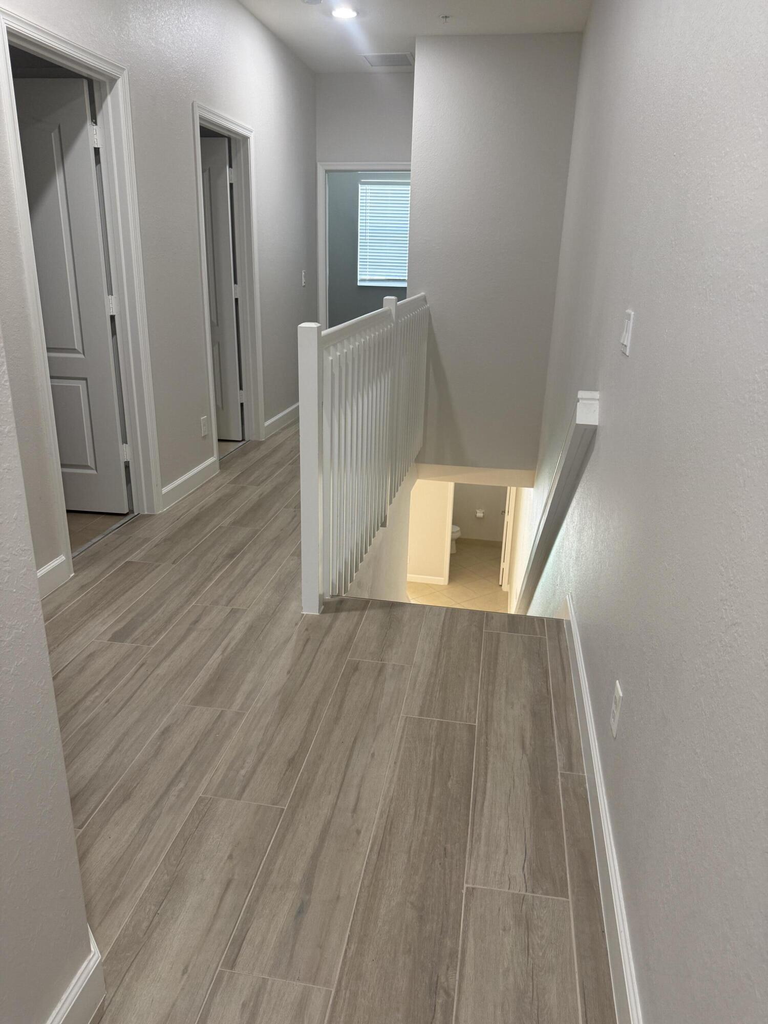 9519 Southwest Merlin Court Stuart, FL 34997 - Photo 10 of 26 Upstairs hallway
