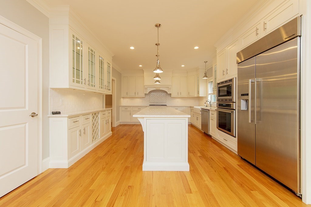 33 Liberty Avenue Lexington, MA 02420 - Photo 3 of 30 a large kitchen with kitchen island a large counter top and stainless steel appliances