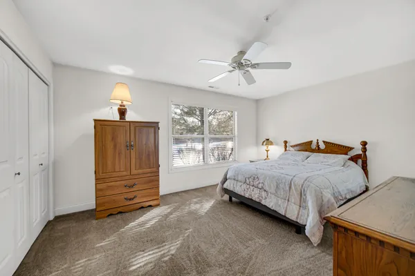 a spacious bedroom with a bed and a window