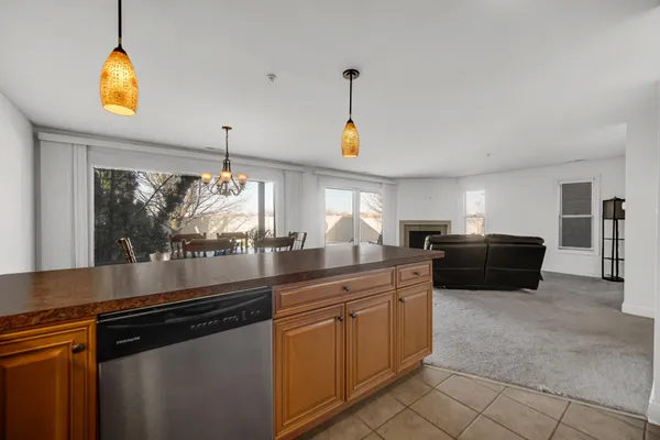 a kitchen with granite countertop a sink and white cabinets