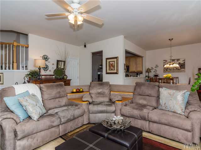 7808 Jeffrey Alan Court Raleigh, NC 27613 - Photo 25 of 25 a living room with furniture and a chandelier