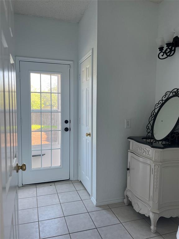 7929 Park Ridge Drive Fort Worth, TX 76137 - Photo 9 of 13 White paneled door with grid-patterned glass insert