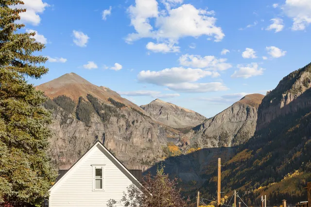 a view of house with sky view and mountains
