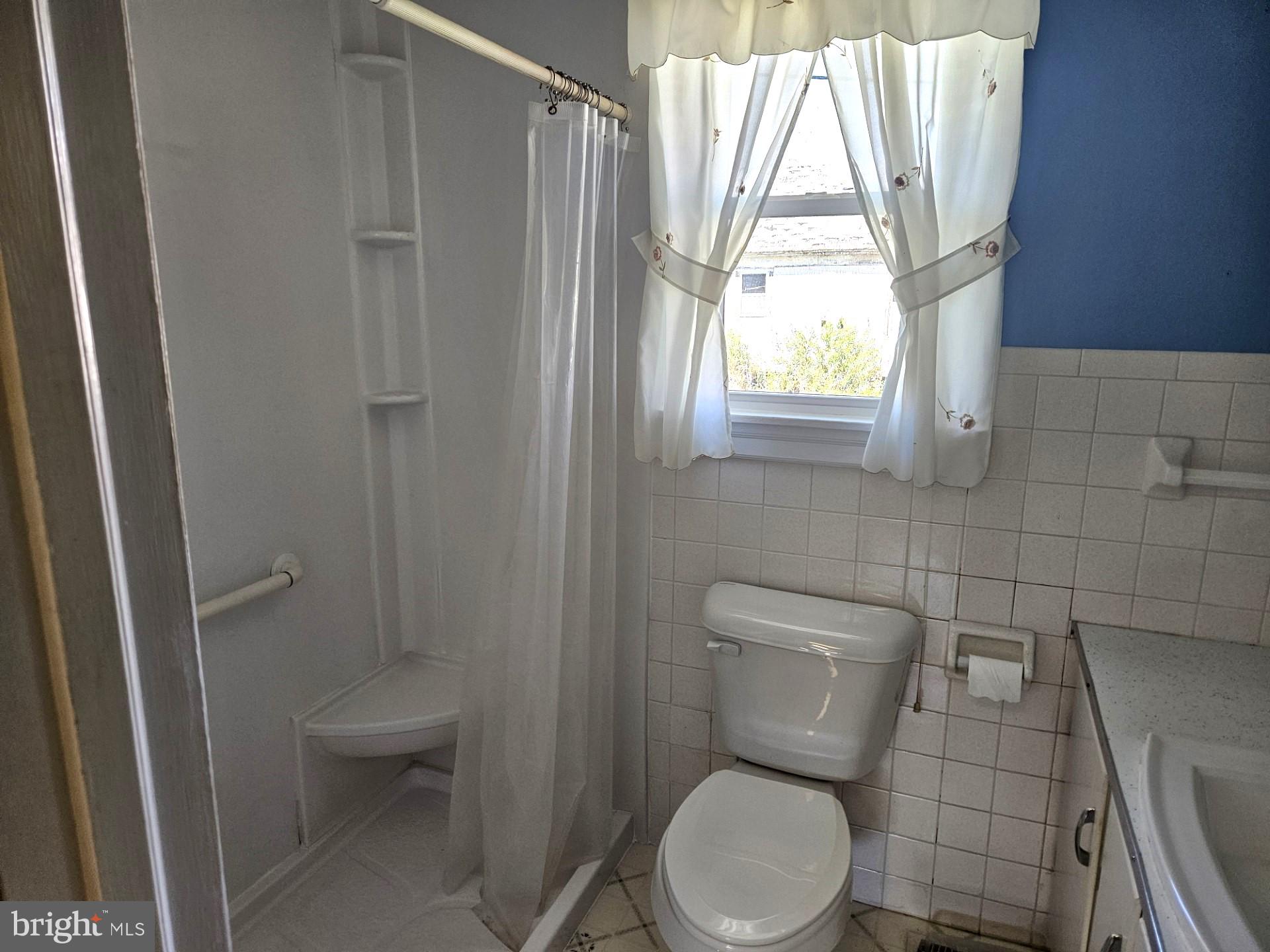 2796 Calvary Road Crisfield, MD 21817 - Photo 12 of 17 a white toilet sitting next to a window in a bathroom