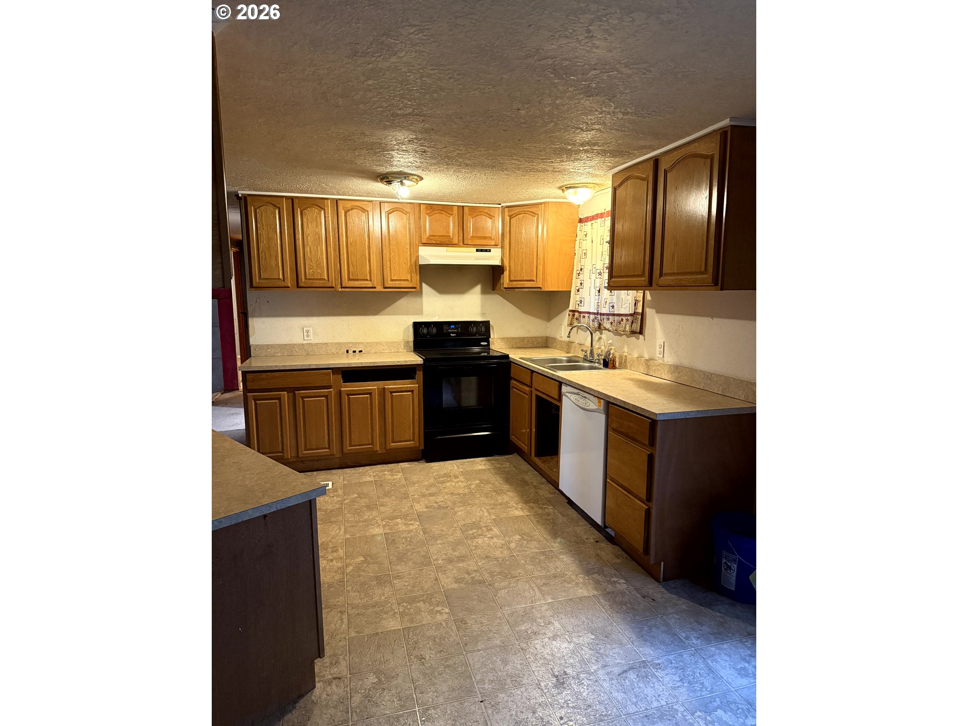 157 Rodgers Road Silverlake, WA 98645 - Photo 23 of 27 a large kitchen with kitchen island a sink stainless steel appliances and cabinets