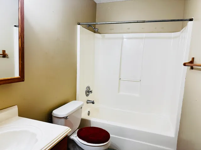 a bathroom with a toilet and a bathtub
