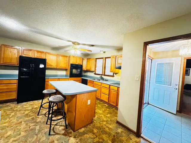 a room with table chairs and a refrigerator