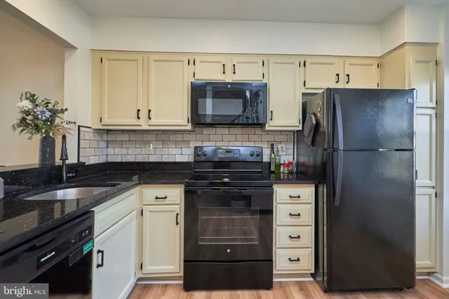 a kitchen with a refrigerator and a sink