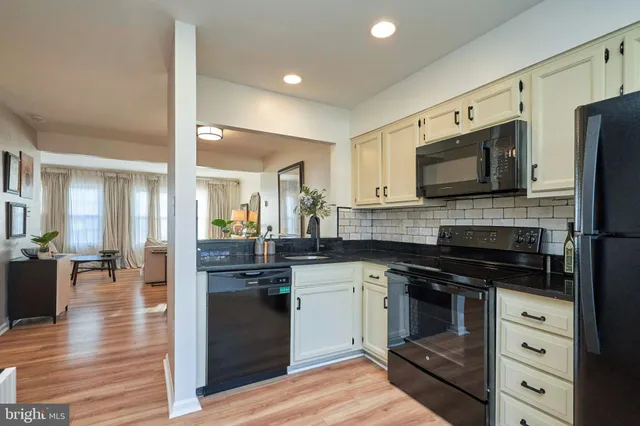 a kitchen with stainless steel appliances a stove sink and cabinets