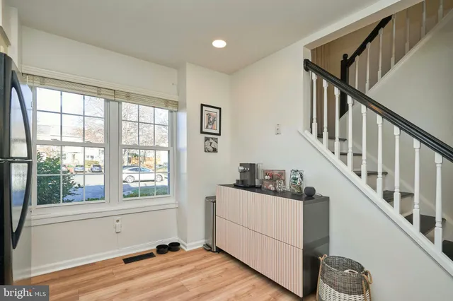 a view of entryway and hall with wooden floor