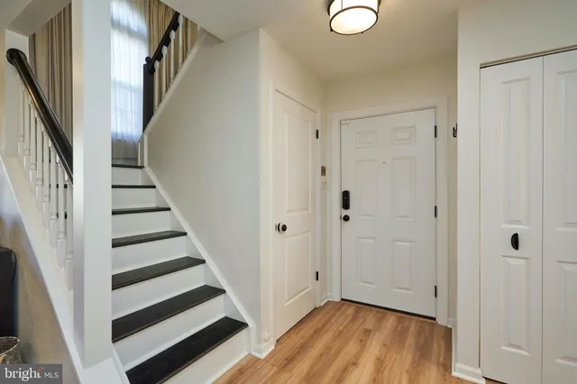 a view of entryway with wooden floor and stairs