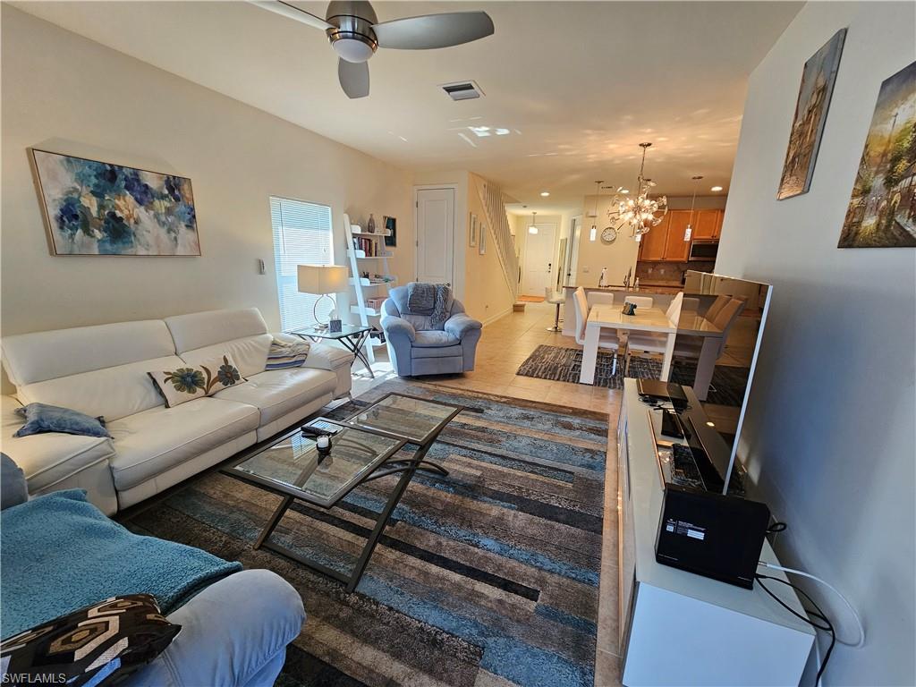 7914 Bristol Circle Naples, FL 34120 - Photo 12 of 22 a living room with furniture and wooden floor