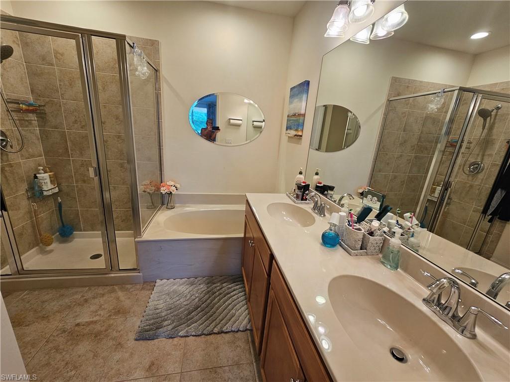 7914 Bristol Circle Naples, FL 34120 - Photo 14 of 22 a bathroom with a tub sink and mirror