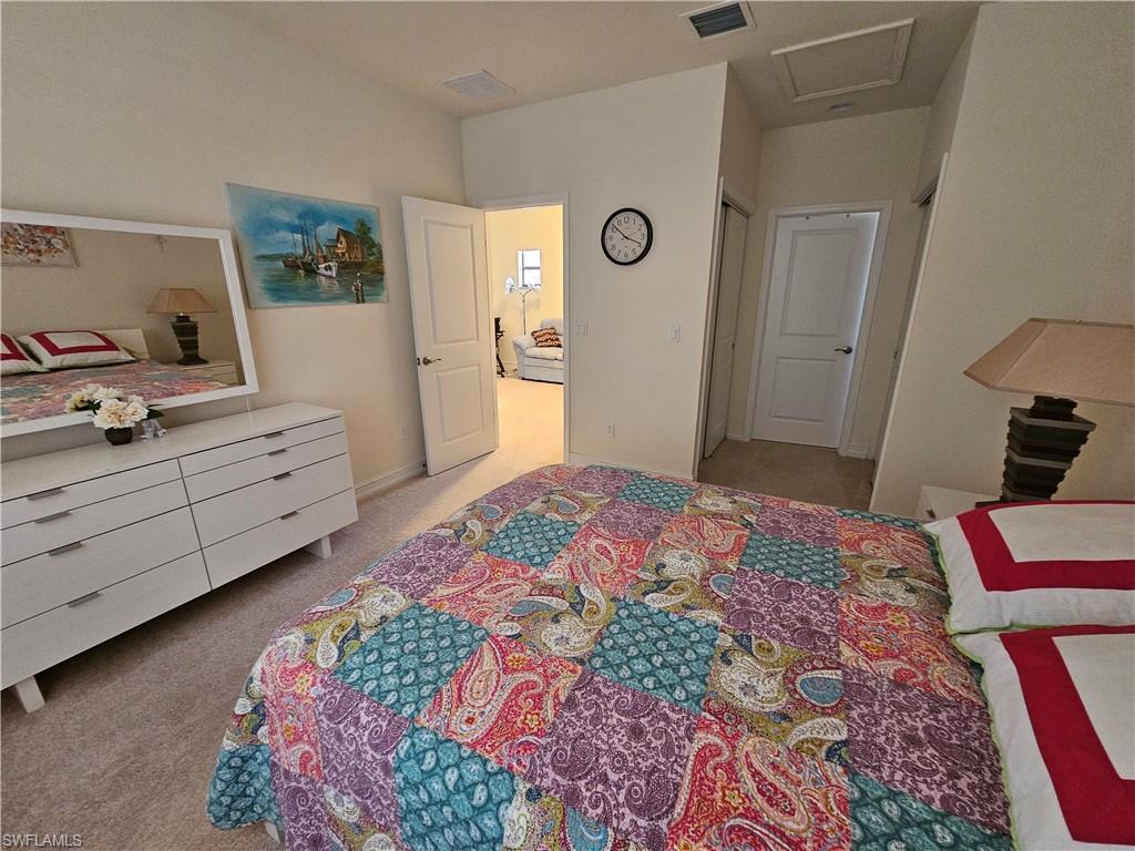 7914 Bristol Circle Naples, FL 34120 - Photo 19 of 22 a bedroom with a bed and a lamp on dresser