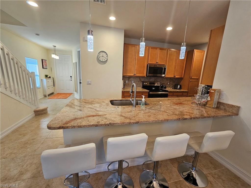 7914 Bristol Circle Naples, FL 34120 - Photo 7 of 22 a bathroom with a granite countertop sink and a mirror