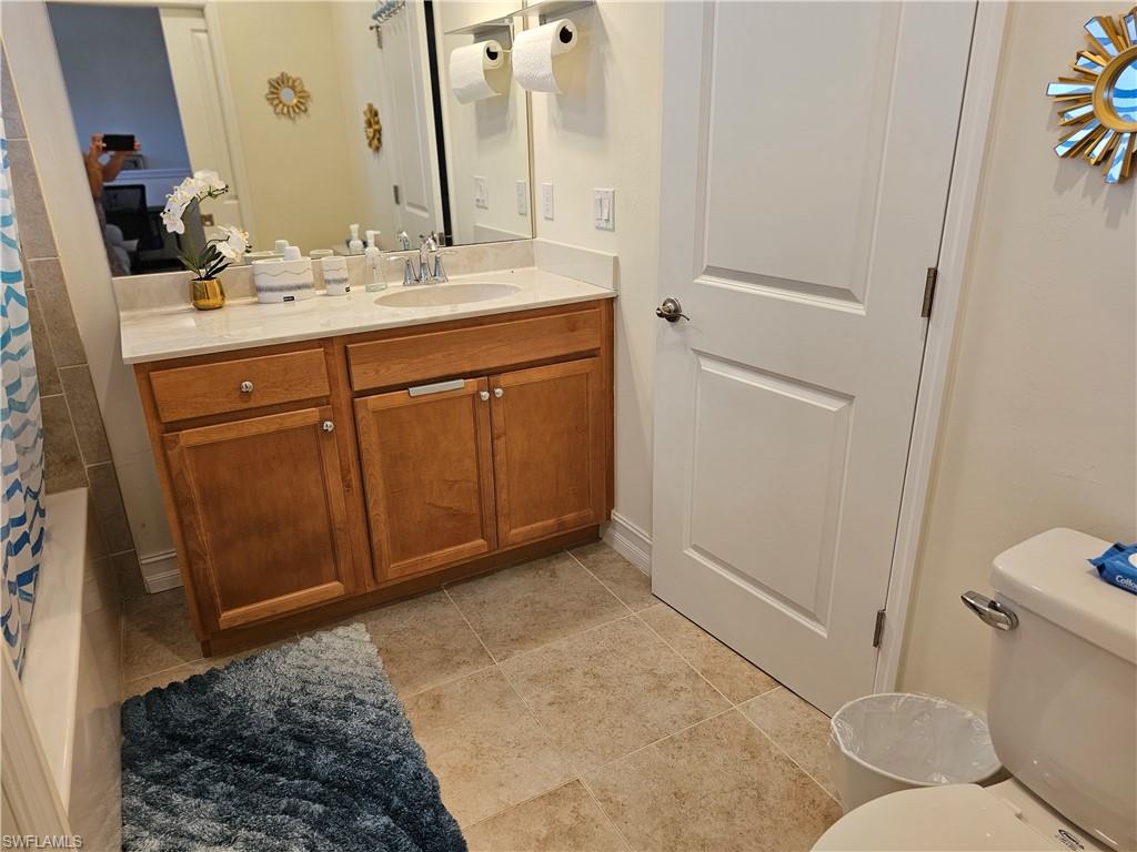 7914 Bristol Circle Naples, FL 34120 - Photo 9 of 22 a bathroom with a sink and a mirror with toilet
