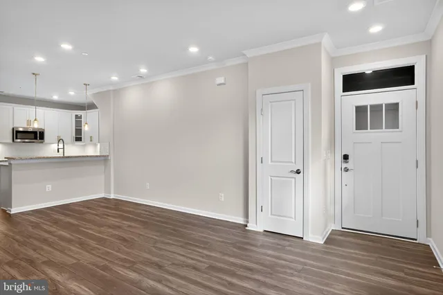 a view of kitchen with wooden floor and electronic appliances